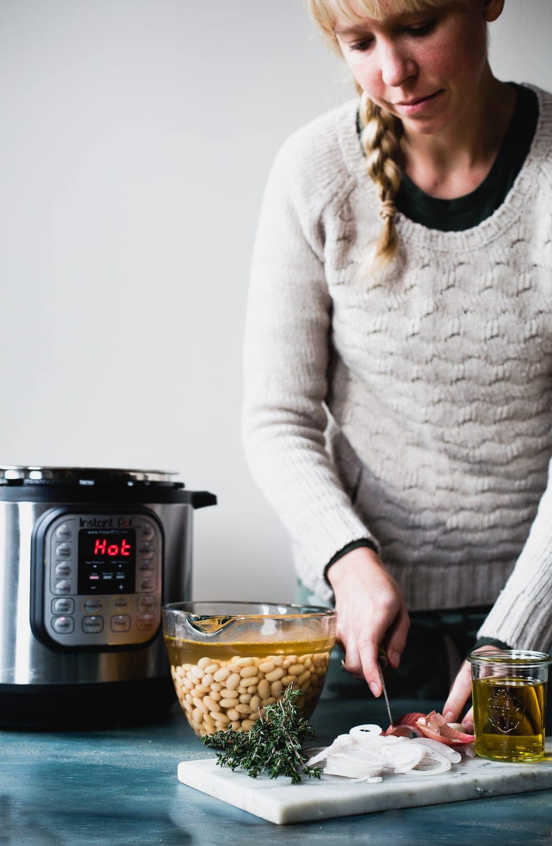 girl cutting onions, preparing ingredients for a soup made in the instant pot