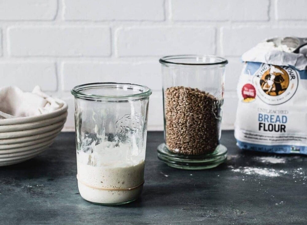 sourdough starter in a jar with flour