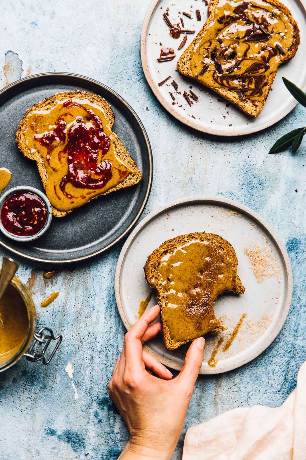 trio of toasts with walnut butter, jam, and chocolate