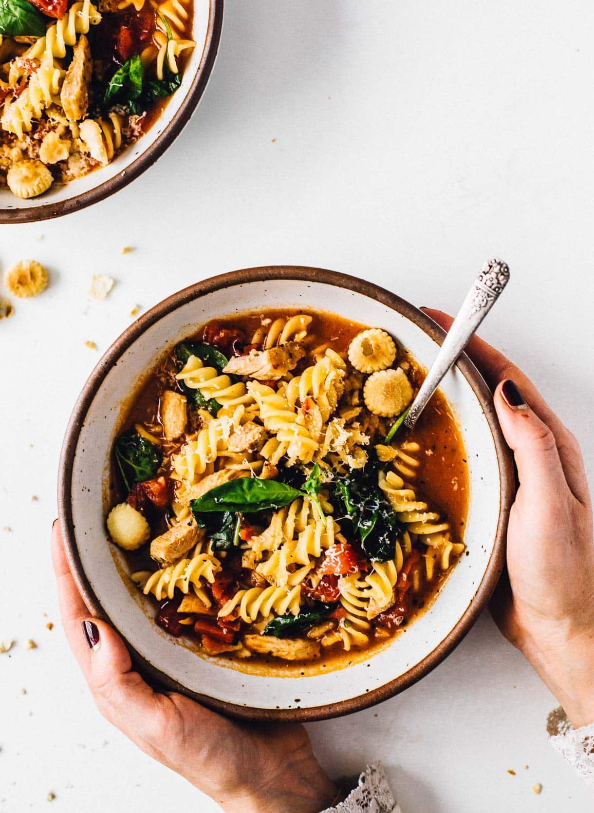 hands around a bowl of turkey tuscan soup