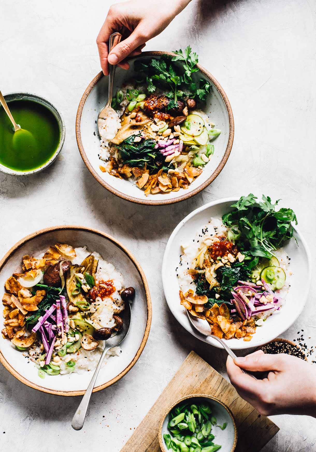 three bowls of instant pot congee, with people's hand in the photo