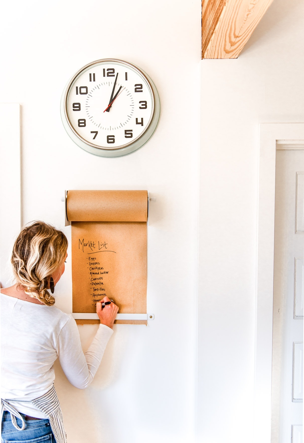 kraft paper roll mounted on wall, underneath wall clock