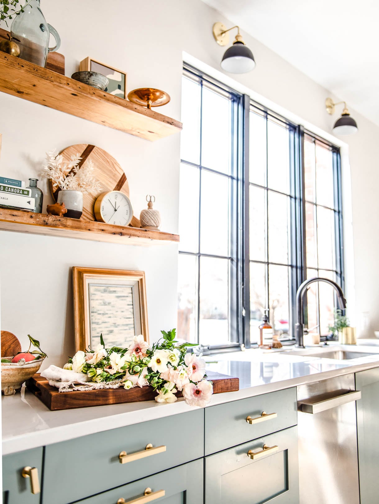 florals on a cutting board with sink in backround against frameless window