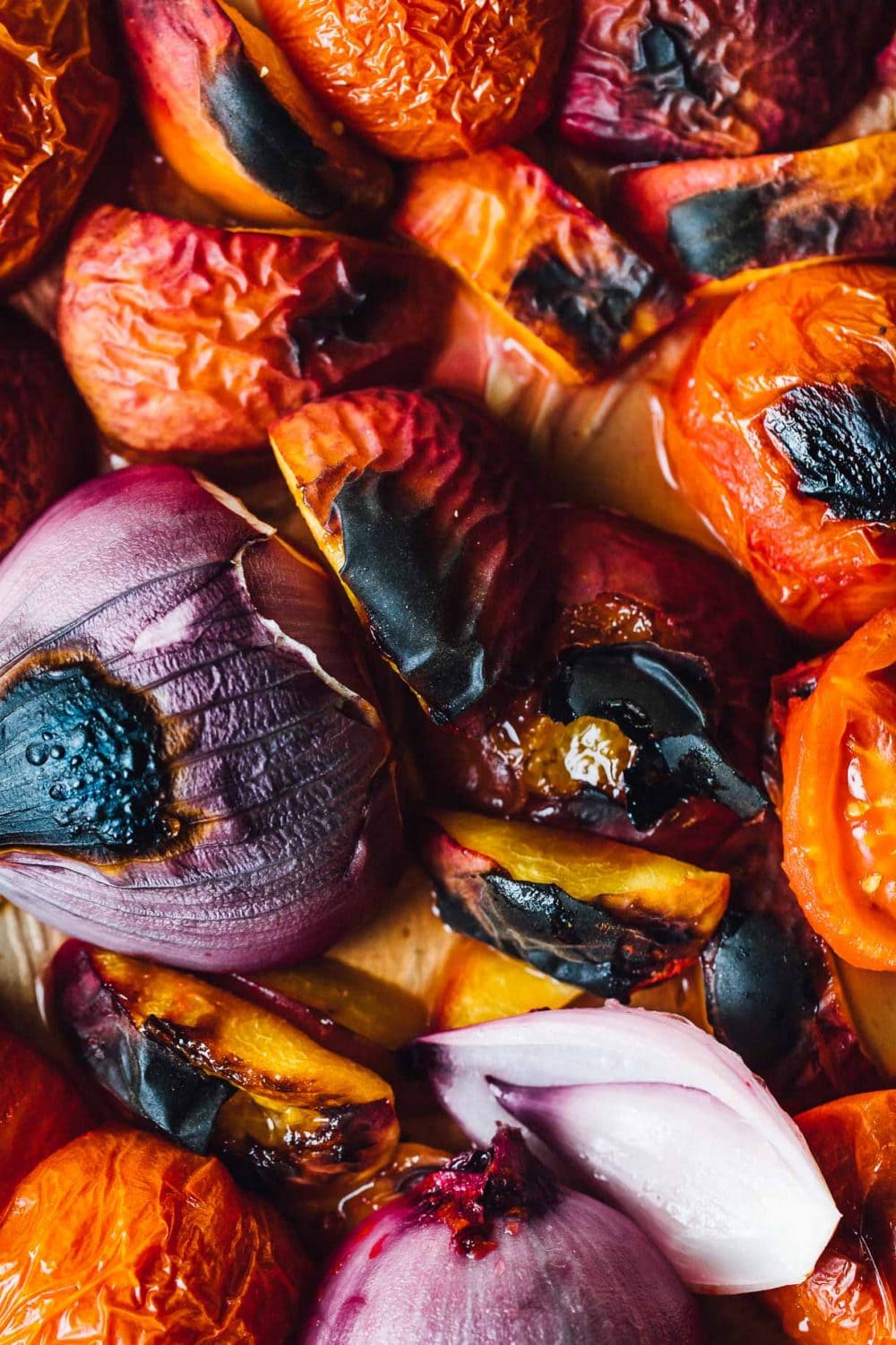 peaches, onions, and tomatoes roasted on a sheet pan