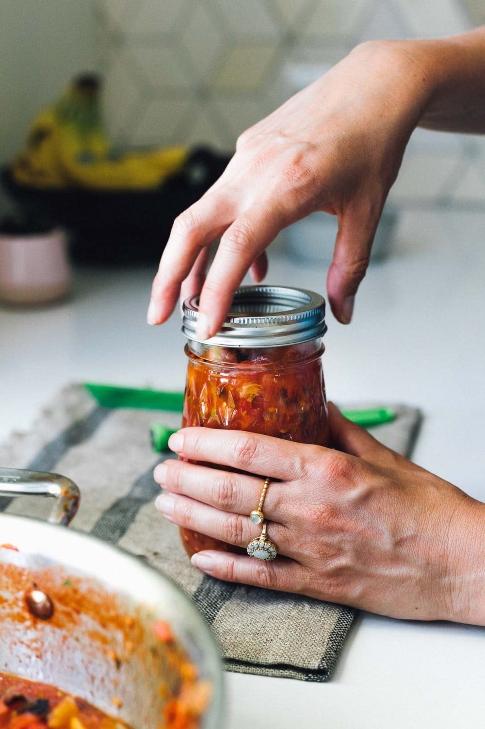 screwing the lid on a jar of salsa