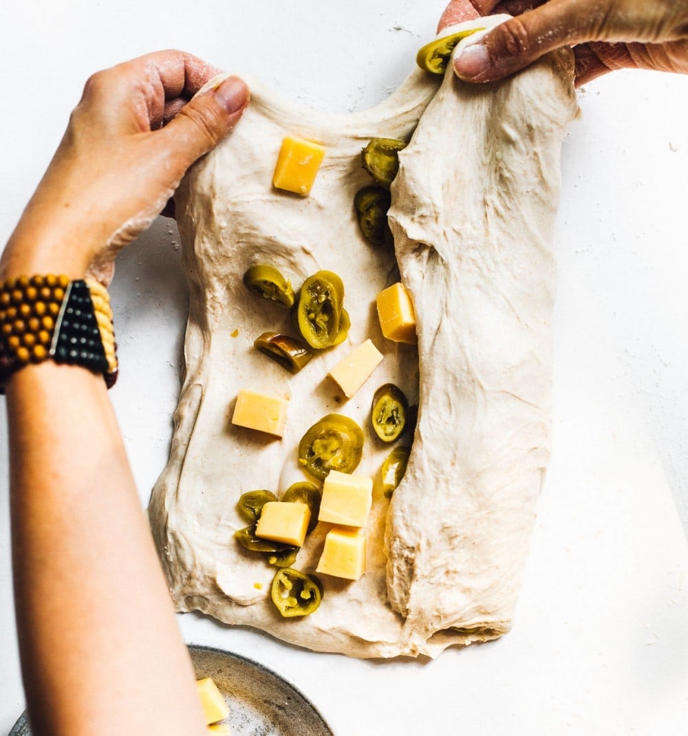 folding cheese and jalapenos into bread dough
