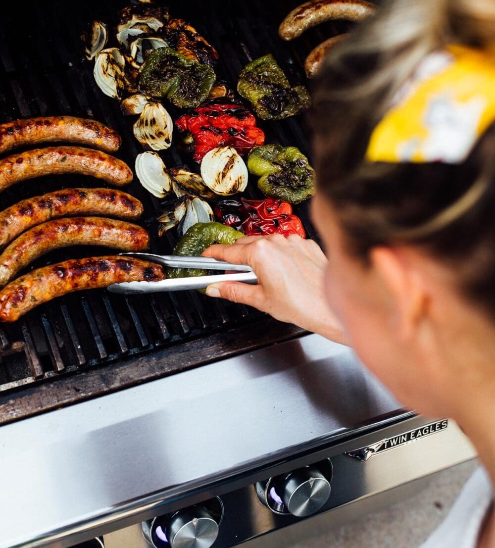 woman grilling brats