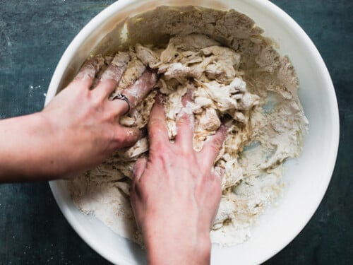 initial mixing of sourdough bread in white bowl