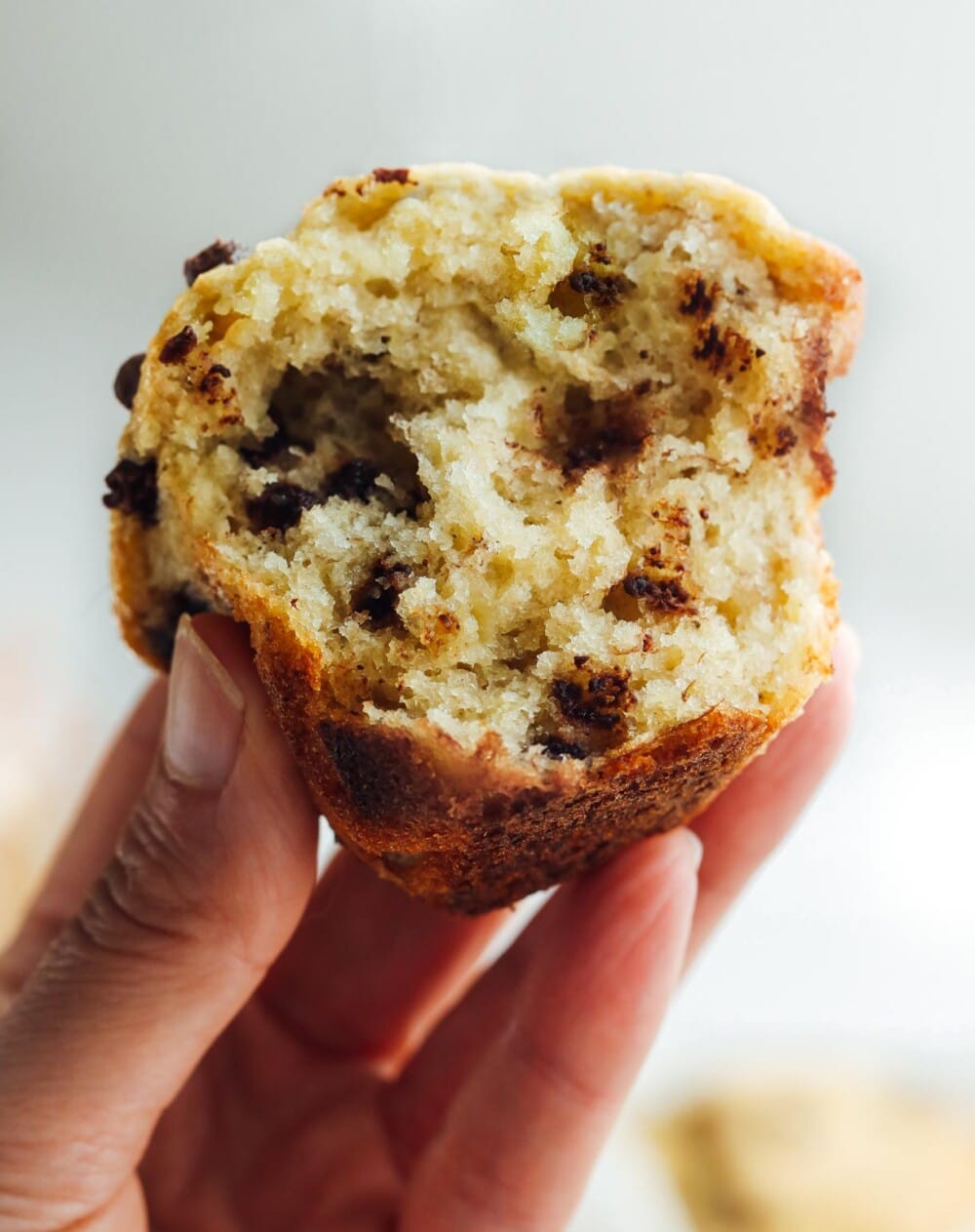 holding a banana chocolate chip sourdough muffin