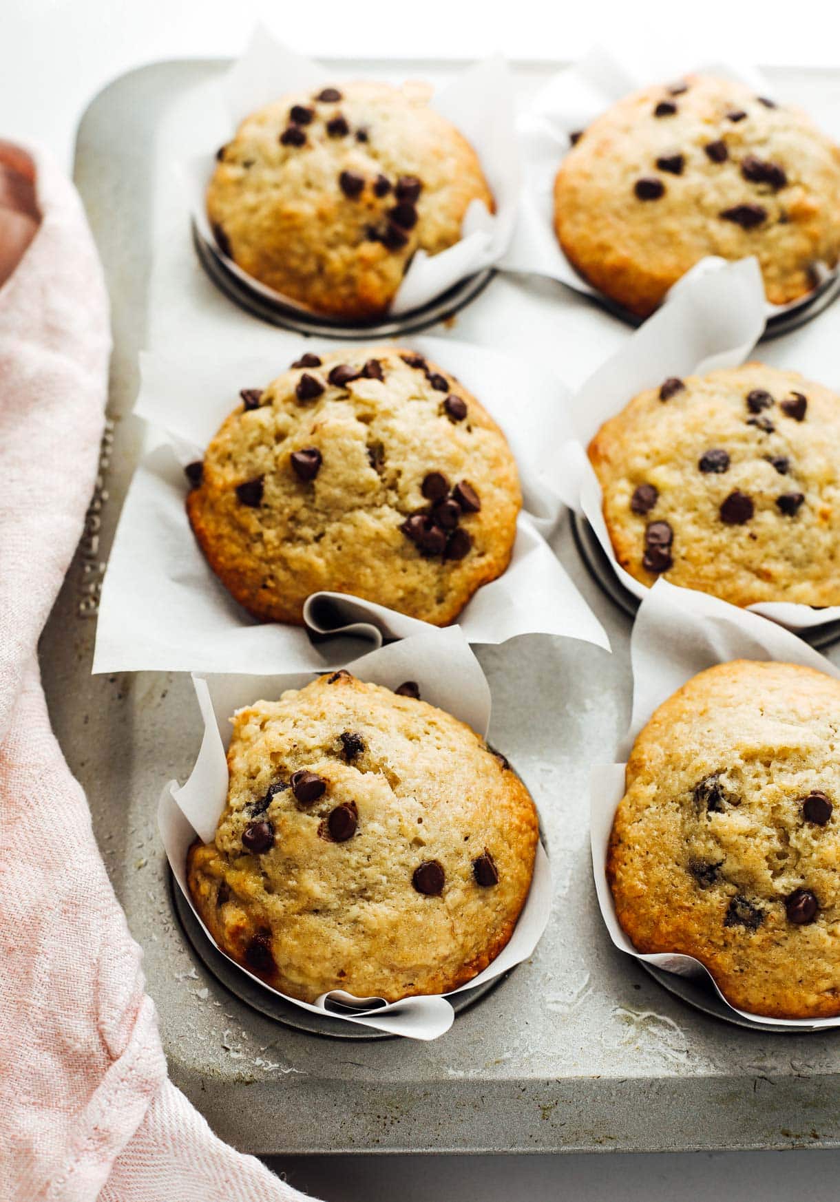 banana chocolate chip sourdough muffins in muffin tin