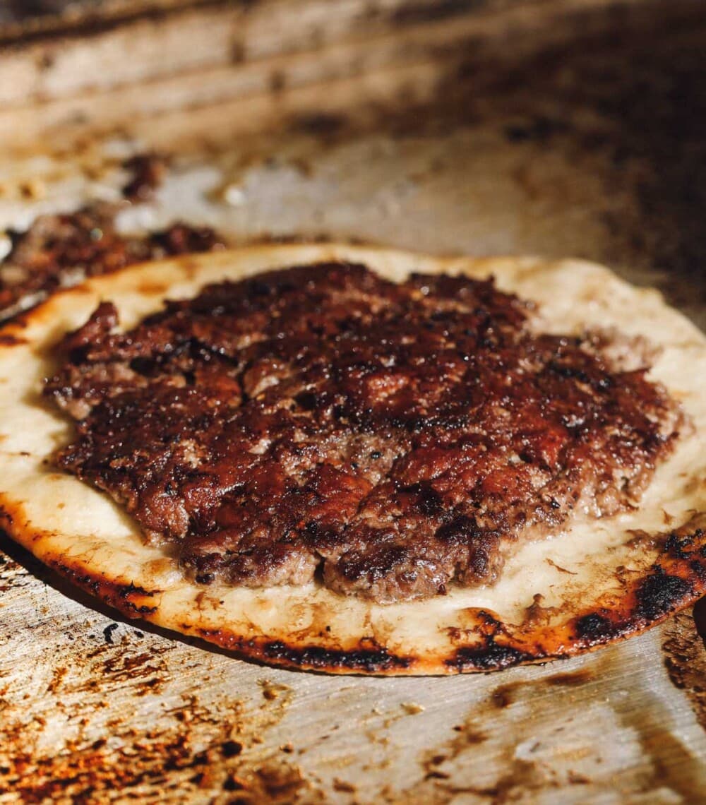 smash burger tacos on a griddle