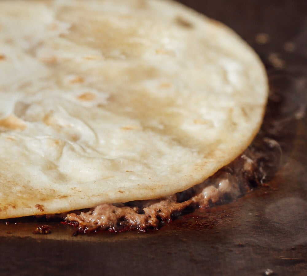 smash burger taco on griddle