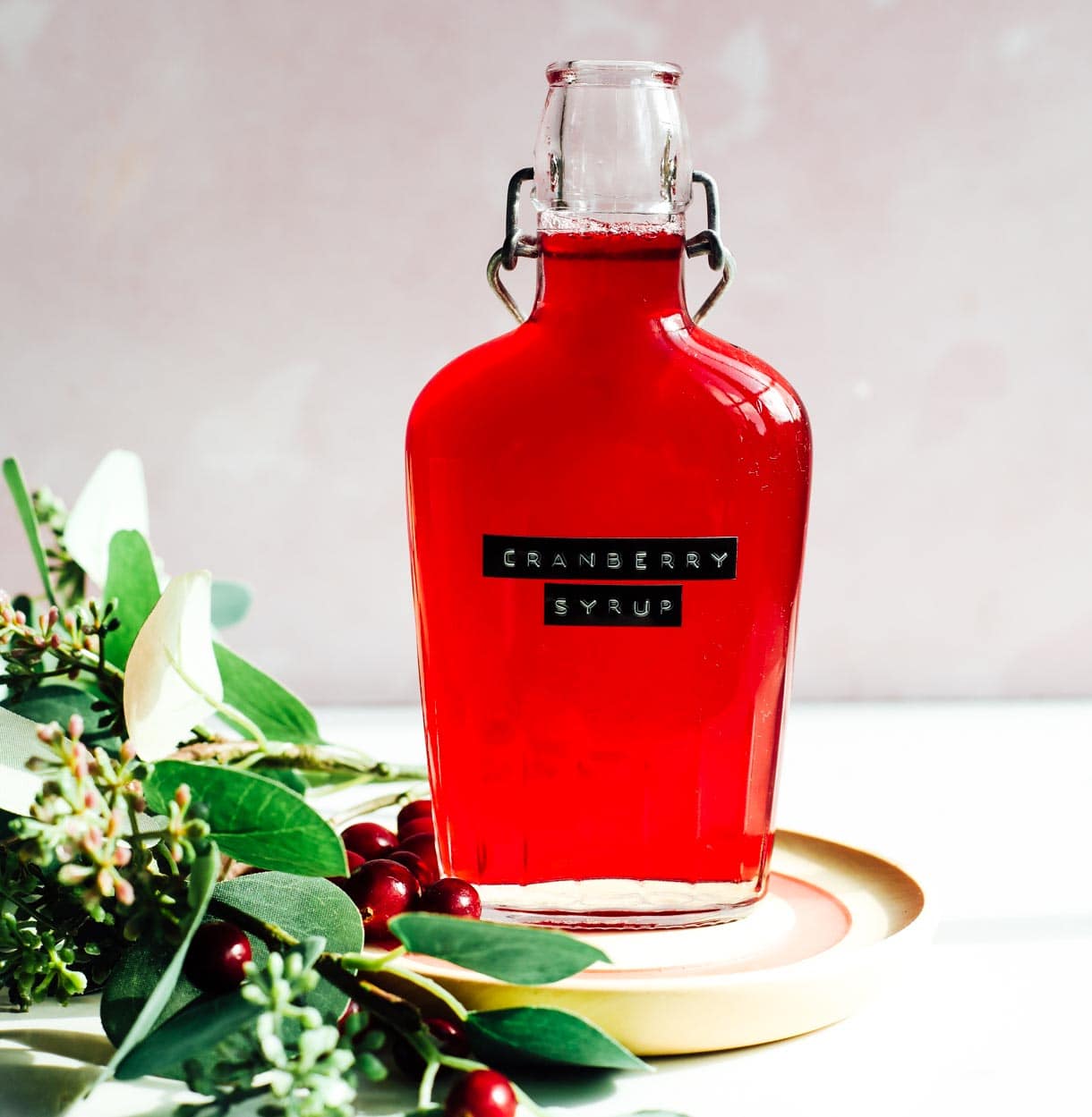 cranberry simple syrup in a glass bottle