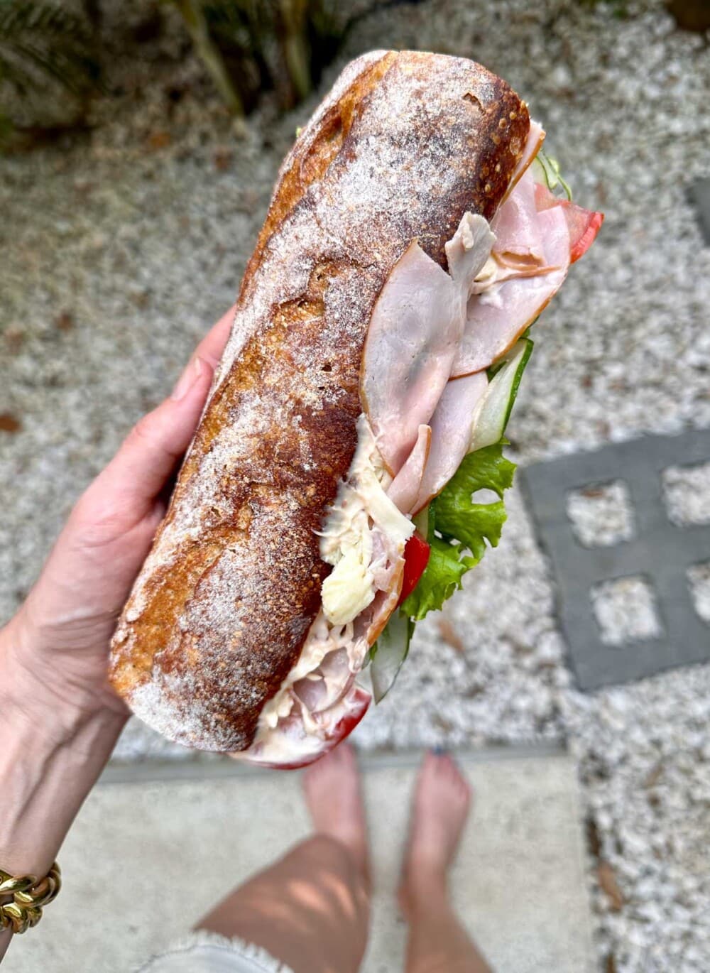 woman holding a sourdough sandwich