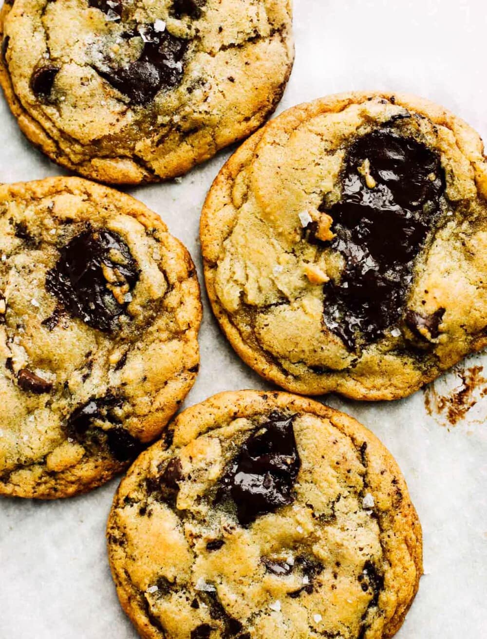 sourdough chocolate chip cookies on white parchment paper