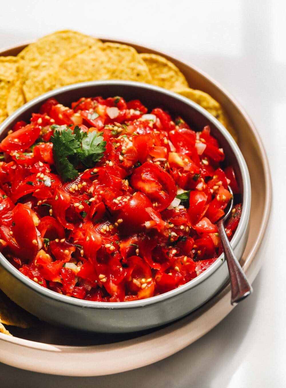 cherry tomato salsa in a bowl with spoon