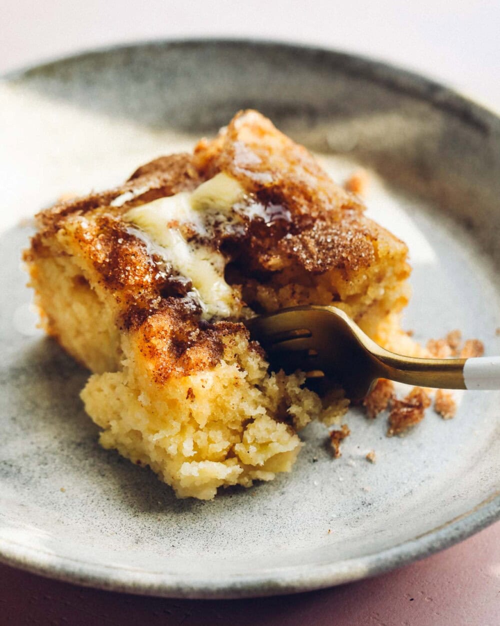 sourdough apple cake on a blue plate with a gold fork