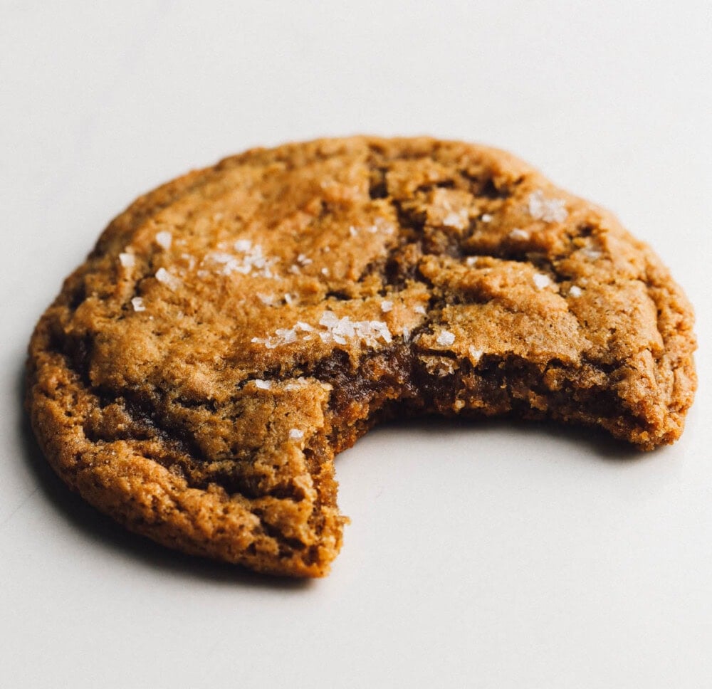 sourdough ginger cookie with bite out of it