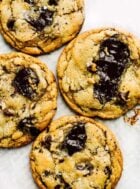 sourdough chocolate chip cookies on white parchment paper